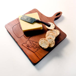 cheese knife shown on cheese board