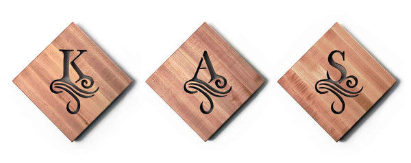 personalized wooden trivets with single initial cut out of the wood