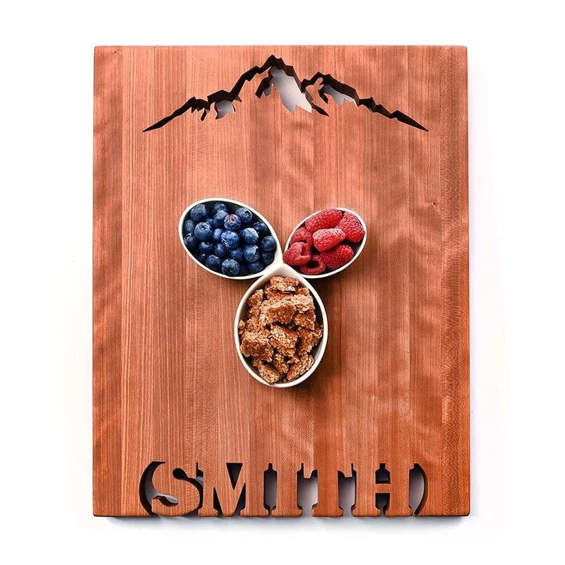 personalized wedding gift cutting board with a mountain cut out and the name Smith
