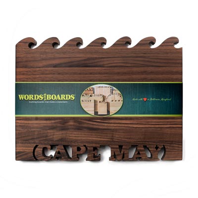 Vertical Walnut Cutting Boards with Waves cutout on top and words Cape Map cut out at bottom