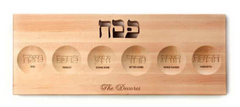 Light Wood Customized Rectangle Seder Plate with engraved family initials in Hebrew at the top - a family name at the bottom - six rounded places for each egg, parley, bone, bitter herbs,horseradish, and haroseth with the english and hebrew names carved in. 